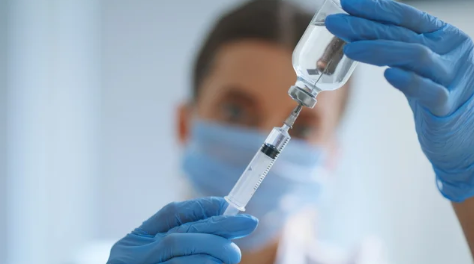 Doctor preparing lipotropic injection vial for metabolic wellness treatment plan